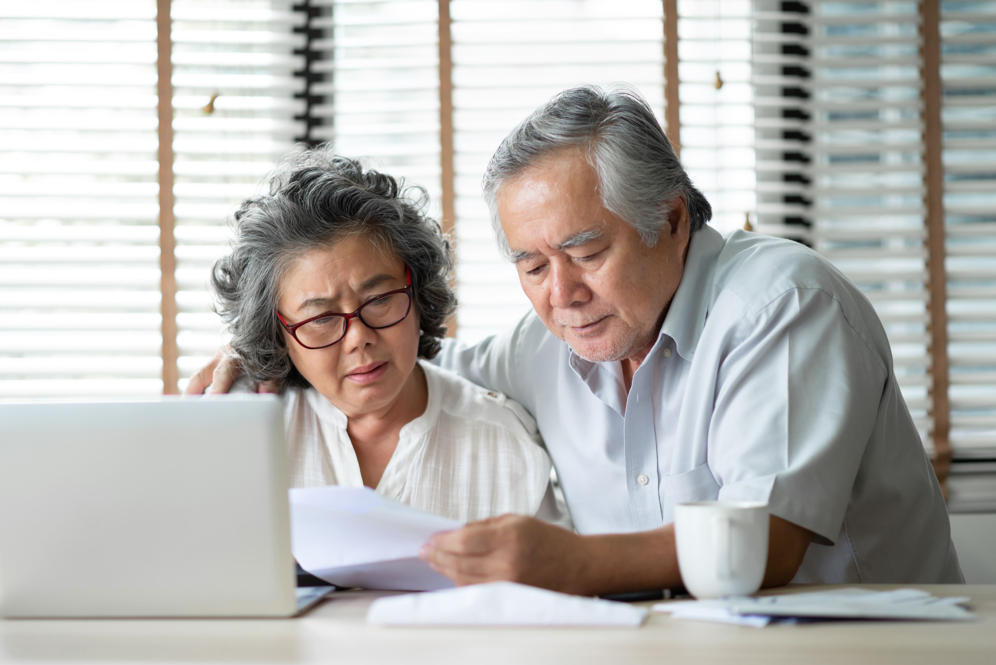 Seniors discussing medical coverage with nurse